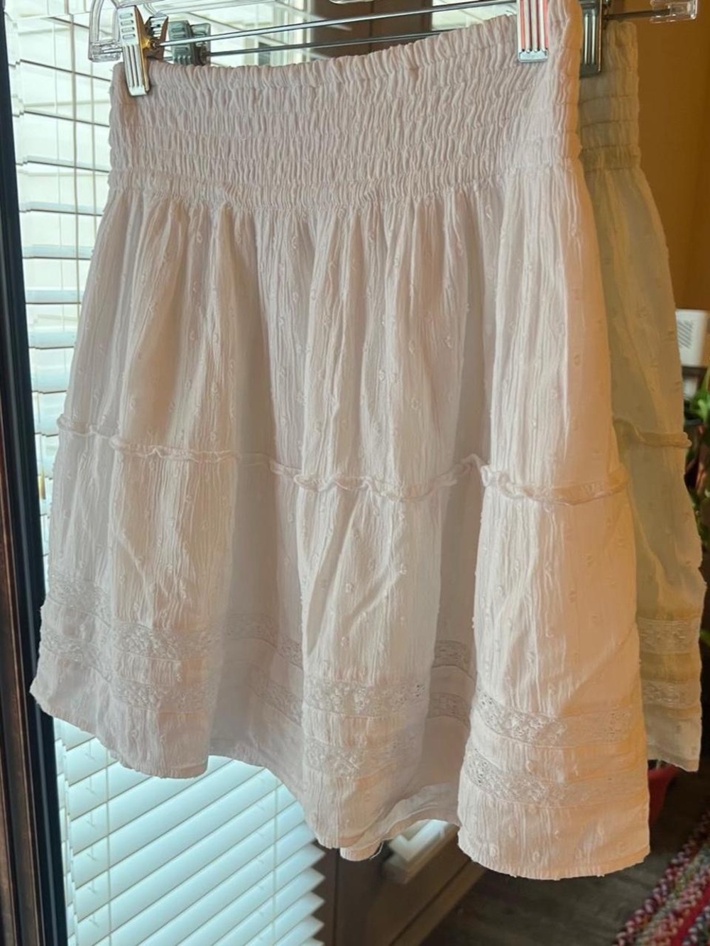 White tiered mini skirt, crochet lace and swiss dot details